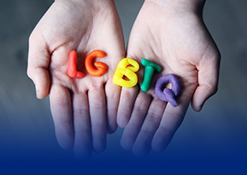 hands holding LGBTQ letters